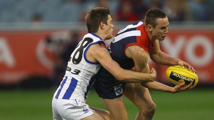 Rising stars Tom Scully of Melbourne and Ryan Bastinac collide.