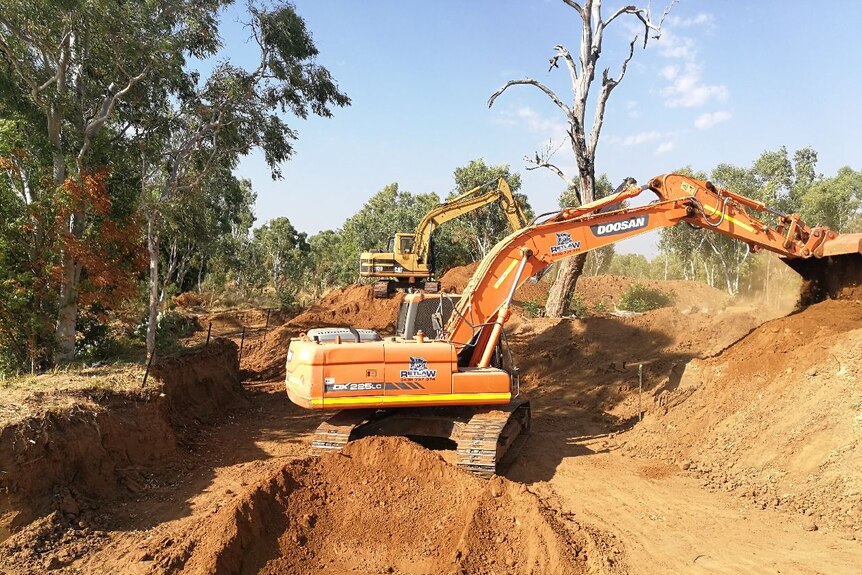 A photo of a digger searching for human remains at Fitzroy Crossing in Western Australia's far north.