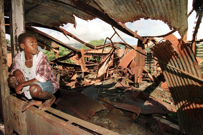 A young man looks at the ruins at the Arawa hospital in 1998. It was once PNG's best hospital, but was destroyed in the war.