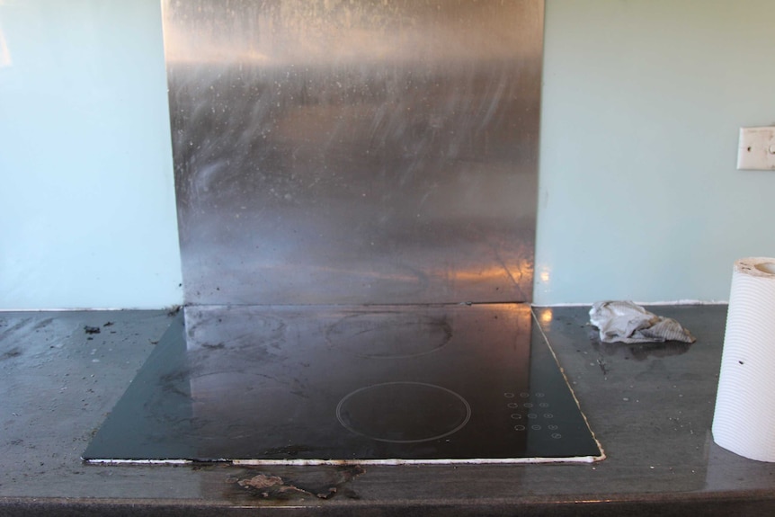 A scorched stove top after a kitchen fire.