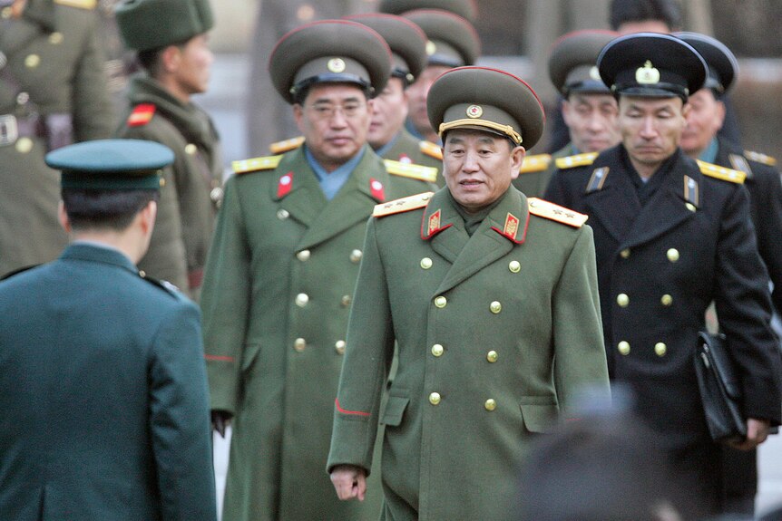 Kim Yong Chol and other military officers are greeted by a South Korean officer.