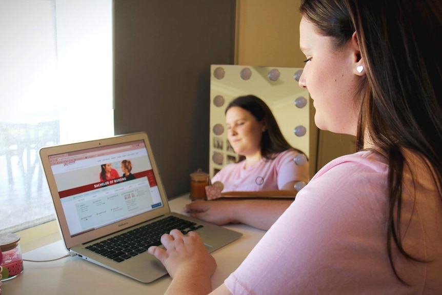 A female student working on her laptop