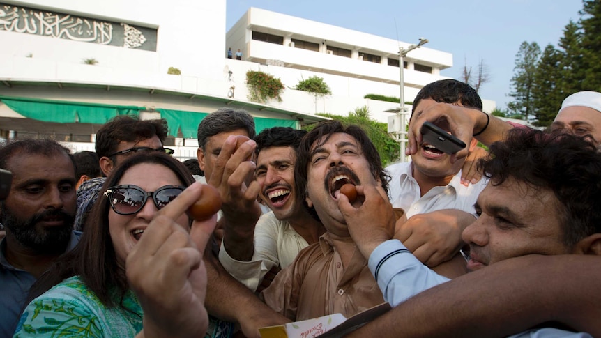 Imran Khan supporters share sweets in celebration