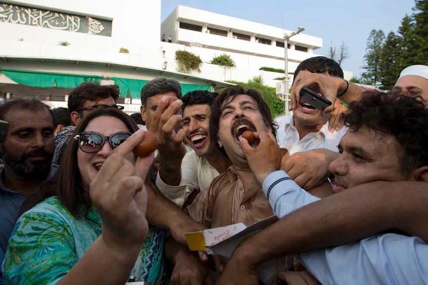 Imran Khan supporters share sweets in celebration