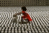 Child labour - young girl stacks bricks in Hyderabad, India