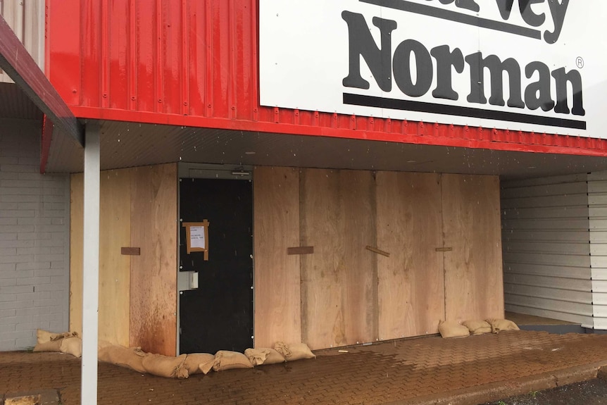 A Harvey Norman store that has been boarded up to protect it from the cyclone.