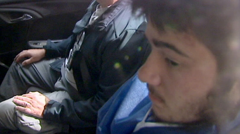 Sevdet Besim inside car being taken into court