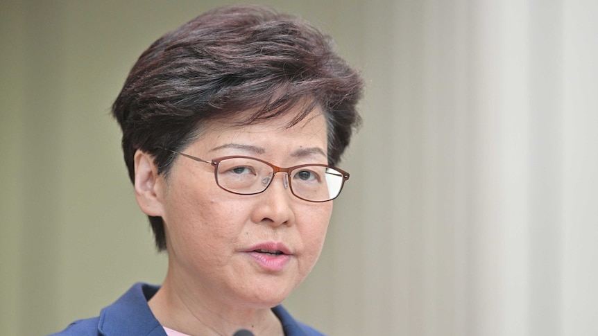 Carrie Lam speaks into the microphone at the press conference.