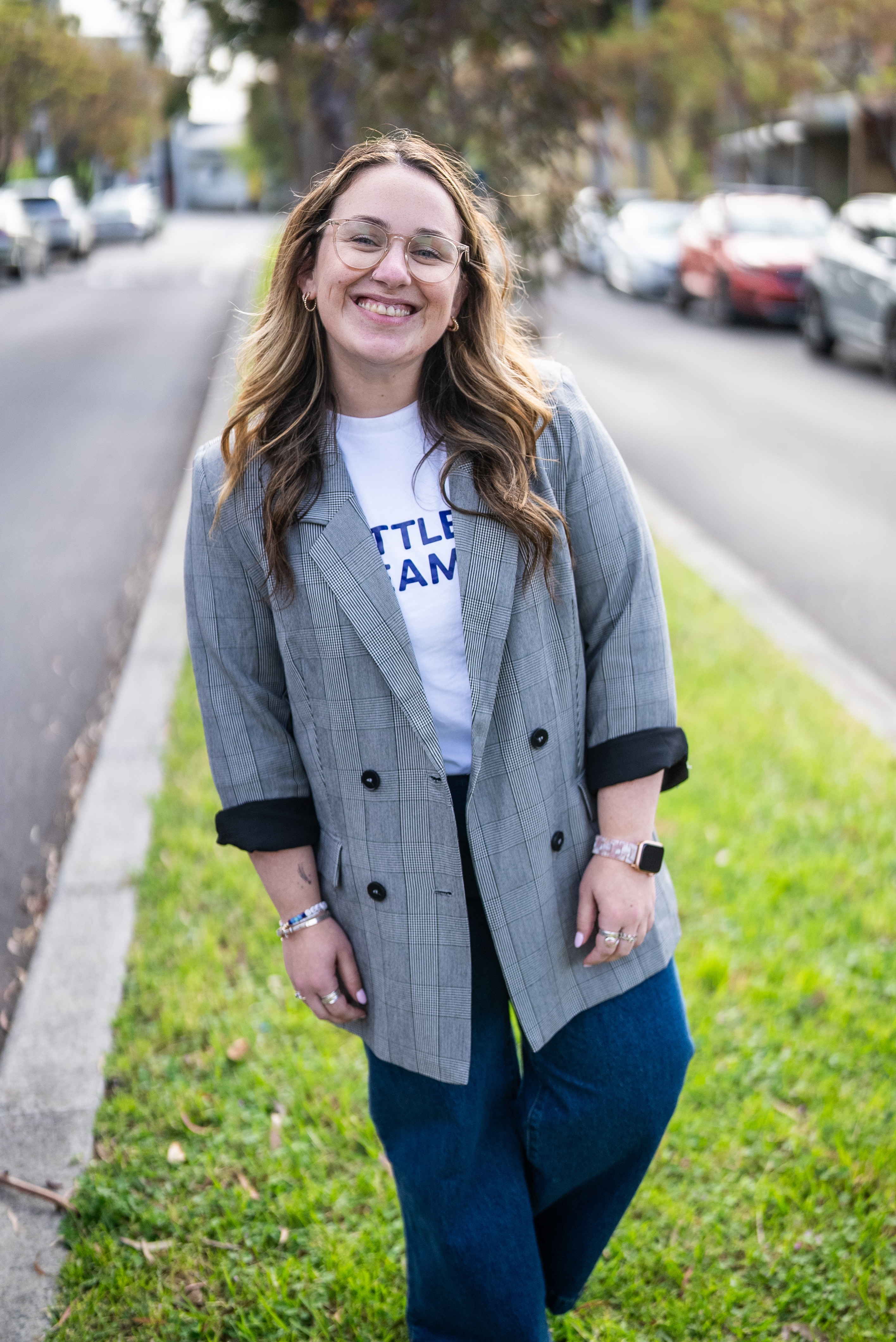 Maddy Buchner smiles for the camera while standing on a grassed traffic island.