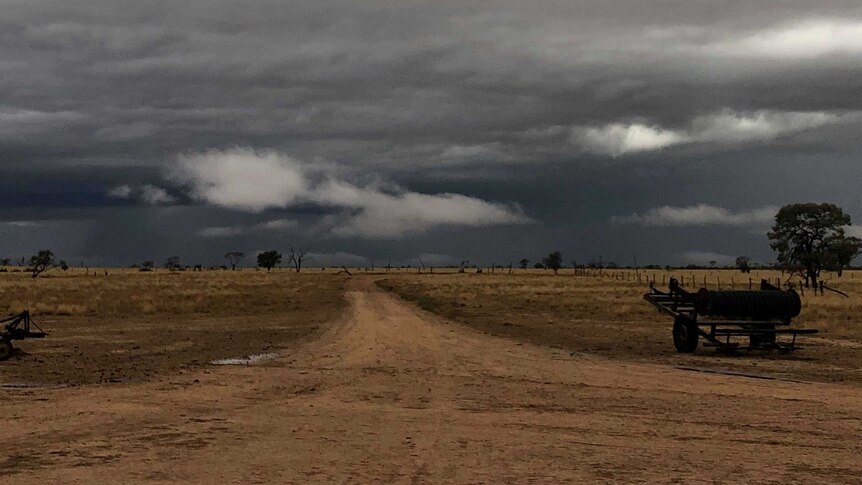 Dark ominous clouds hand over a rural property
