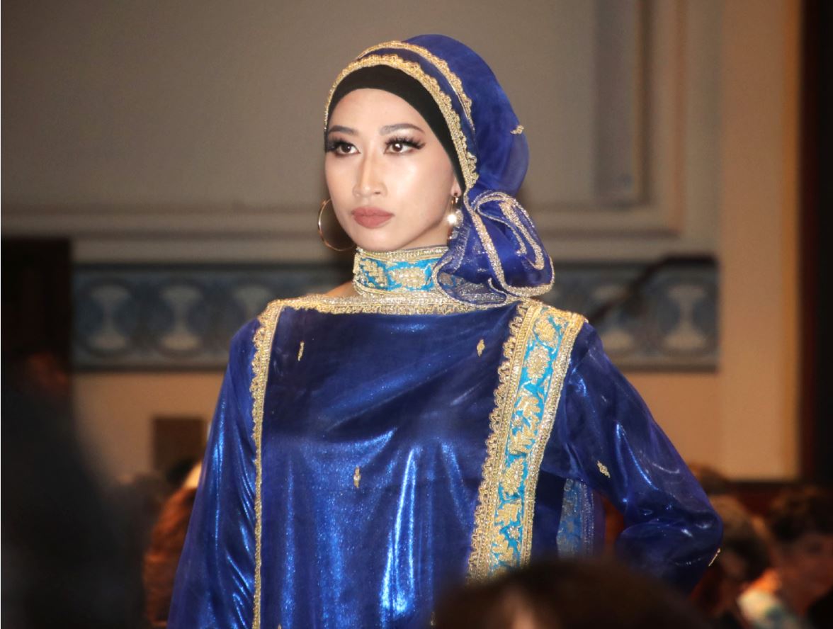 Perth fashion show model wears a blue dress with head scarf.