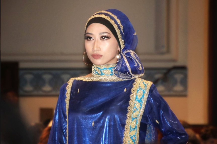 Perth fashion show model wears a blue dress with head scarf.