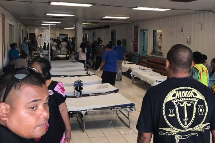 Inside a hospital room lined with beds