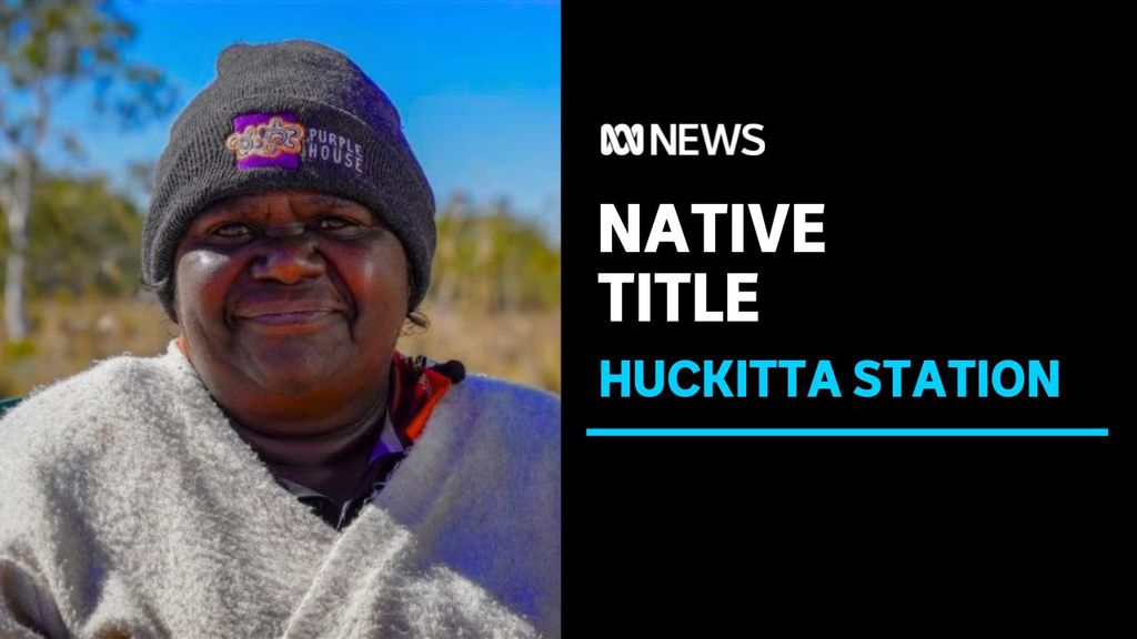 Native Title. Huckitta Station. Woman smiling looking at the camera wearing a beanie.