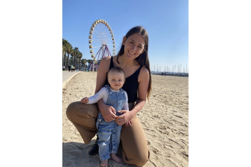 Georgia Jarecki-Warke holding her child on the beach