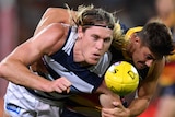 Mark Blicavs gets a hand pass away as he is tackled by Riley Knight.