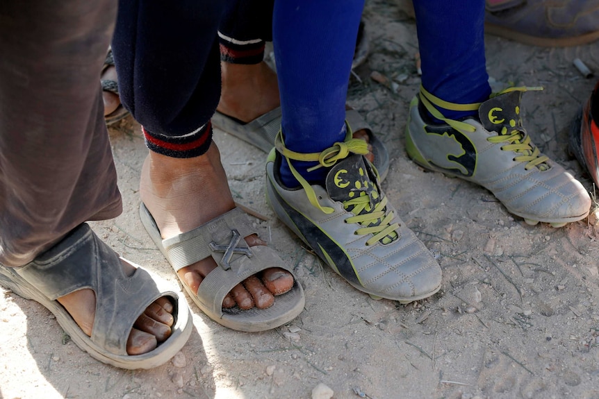 Two sandals and a pair of football boots.