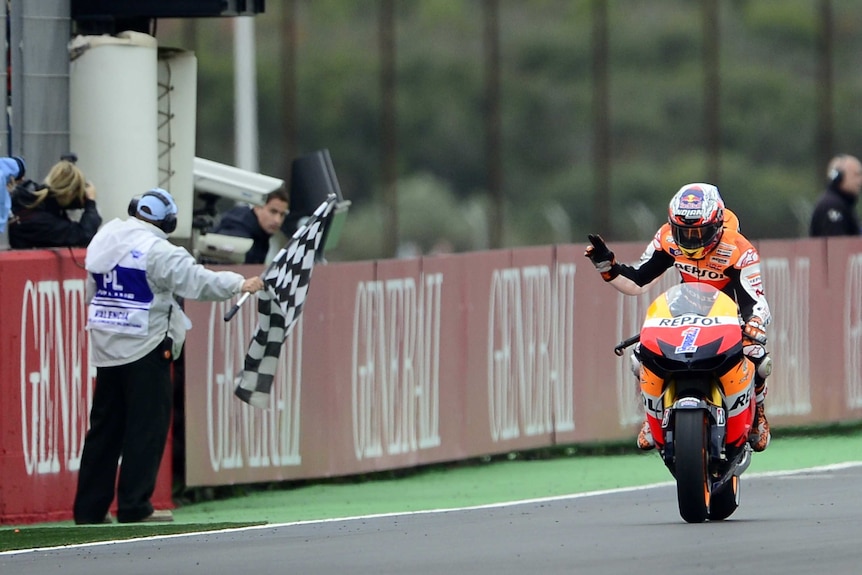 Third-place finish ... Casey stoner passes the chequered flag for the last time.
