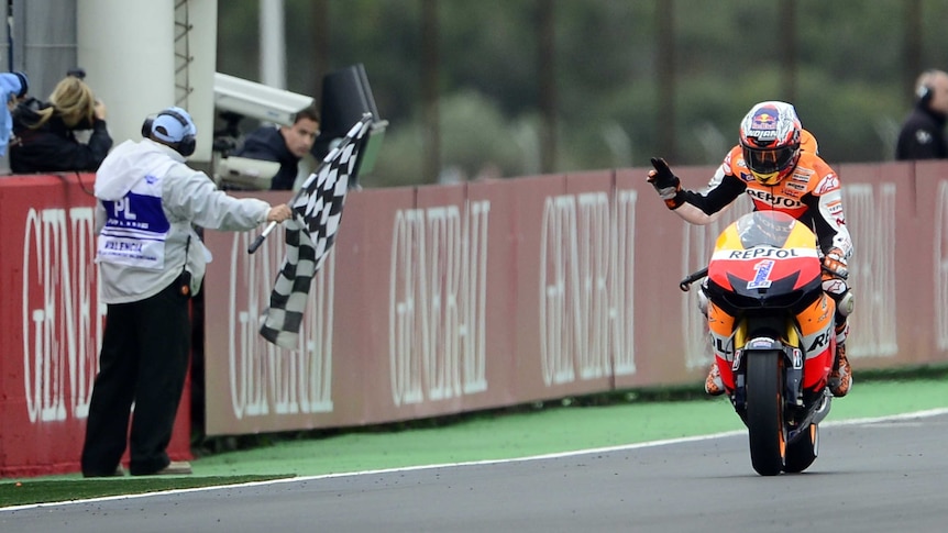 Third-place finish ... Casey stoner passes the chequered flag for the last time.