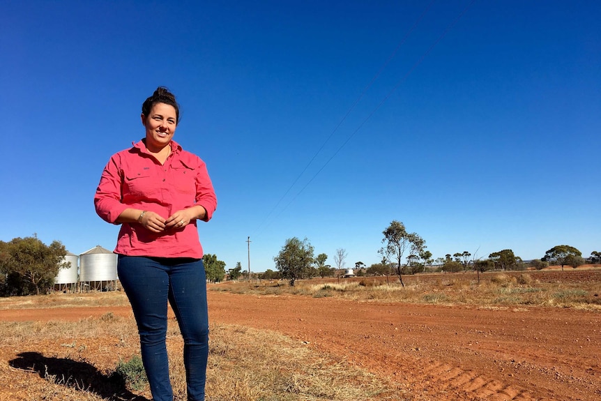 A woman stands on a farm in Western Australia.