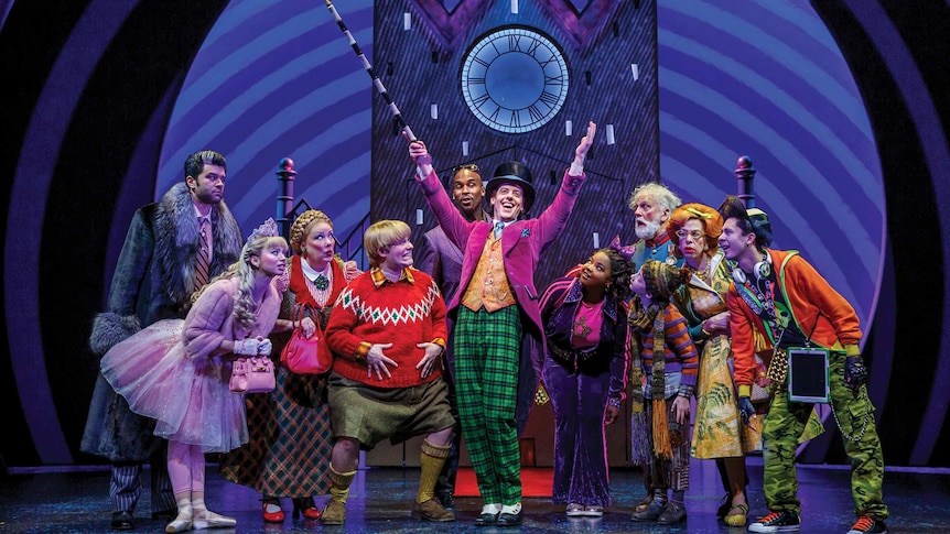 The American cast of Charlie and the Chocolate Factory on stage with Willy Wonka in the centre.