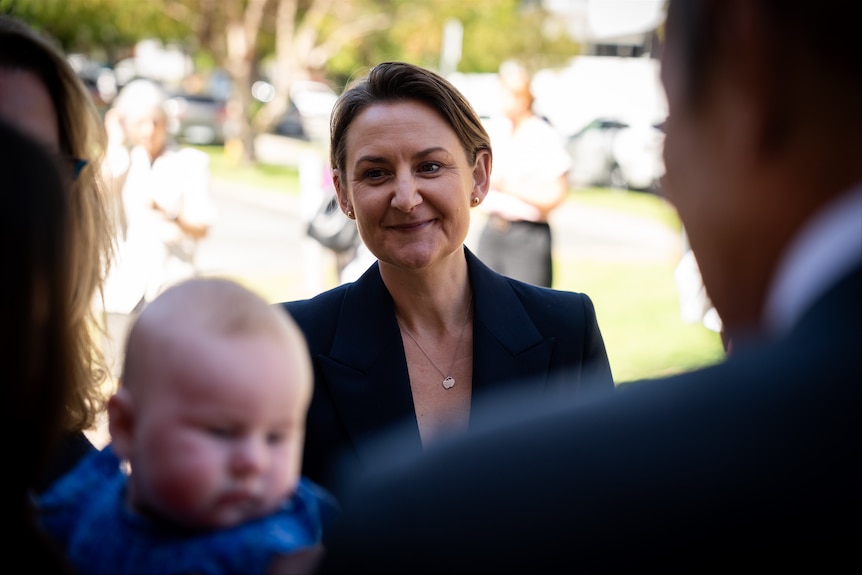 The health minister surrounded by a baby