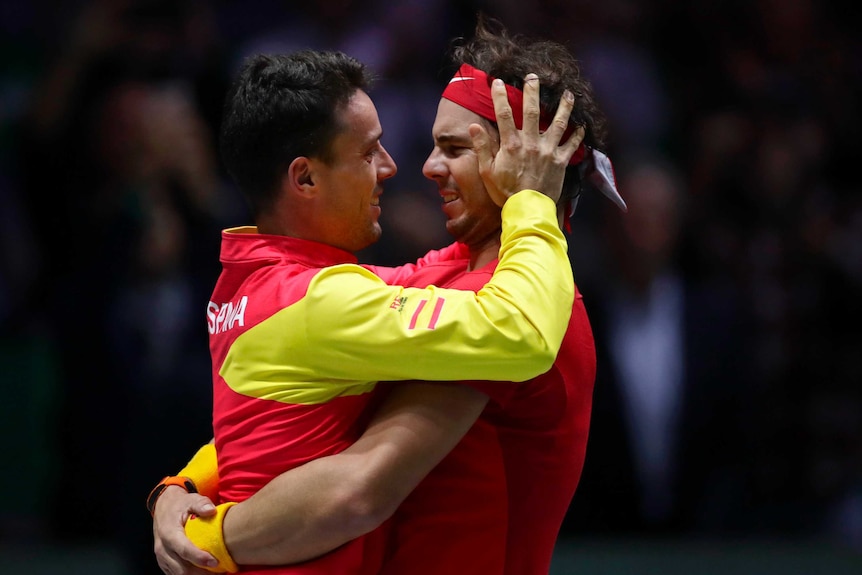 Rafael Nadal hugs Roberto Bautista Agut, who holds Rafa's head in his hands