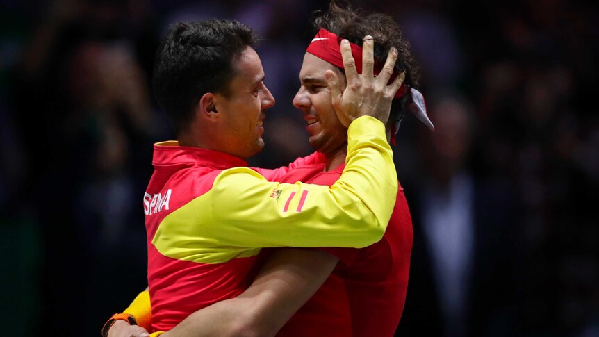 Rafael Nadal hugs Roberto Bautista Agut, who holds Rafa's head in his hands