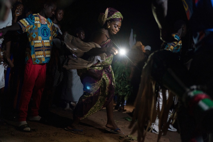 Woman performs ritual dance in Gambia.