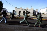 Israeli security personnel run to scene
