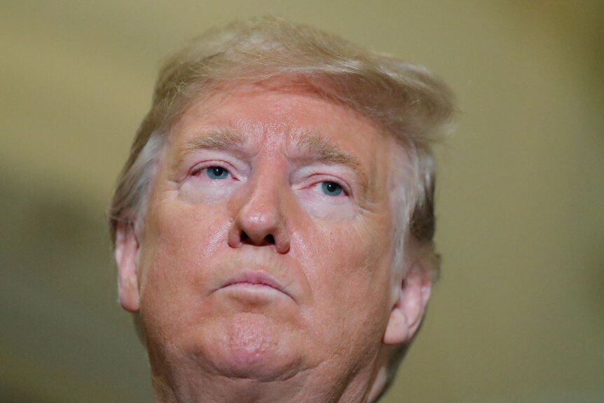 Donald Trump casts a stern glare.