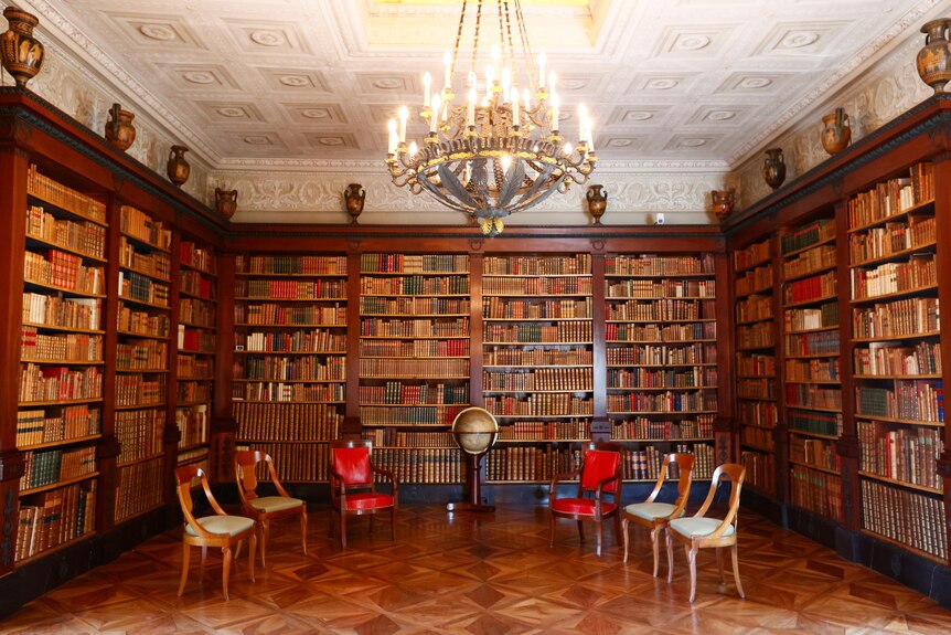 A seating arrangement and walls of books in the library where Mr Biden and Mr Putin will meet in Geneva.