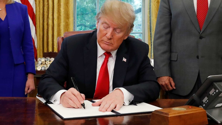 Donald Trump signs an executive order