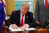 Donald Trump signs an executive order