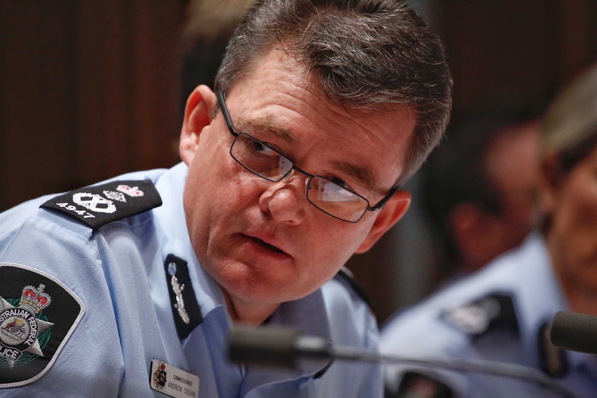 Commissioner Colvin prepares to talk into the microphone at the Senate Estimates