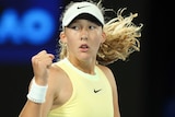 Mirra Andreeva pumps her right fist after winning a point at the 2024 Australian Open.
