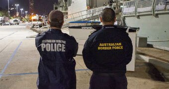 An Australian Federal Police officer and an Australian Border Force officer.