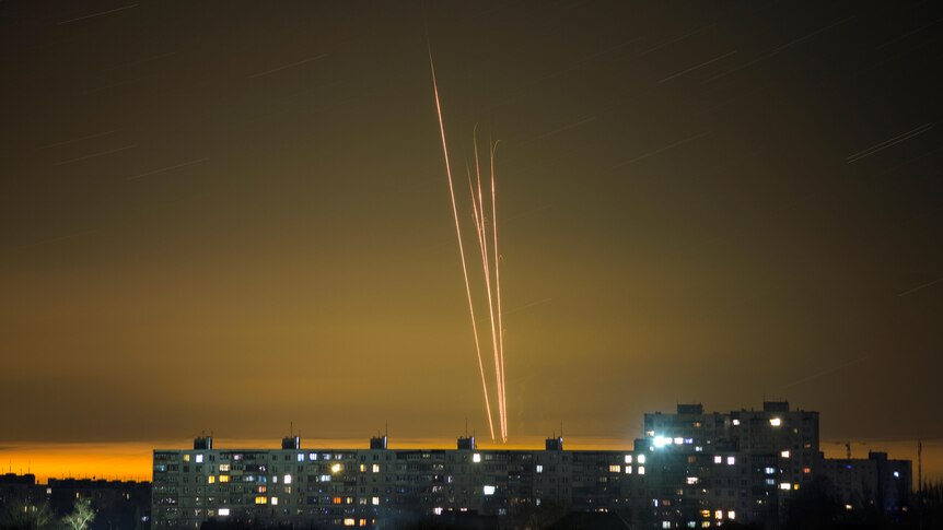 Four Russian rockets launched against Ukraine from Russia's Belgorod region are seen at dawn in Kharkiv.