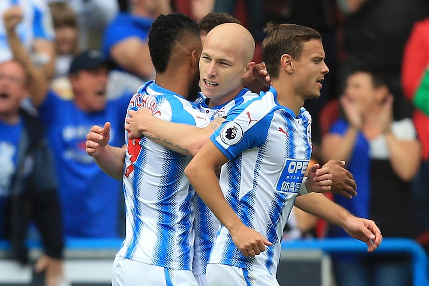 Aaron Mooy is congratulated by teammates with a hug after scoring against Newcastle.