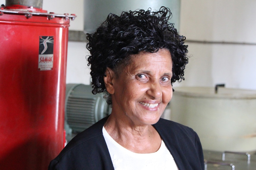 A lady standing inside a coffee roasting warehouse