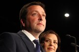 Matthew Guy stands with his wife at a podium.
