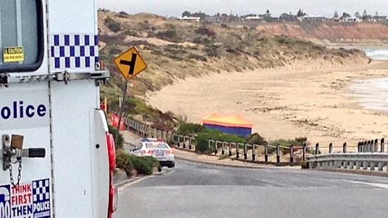 Two police cars at Port Noarlunga where a body was found.