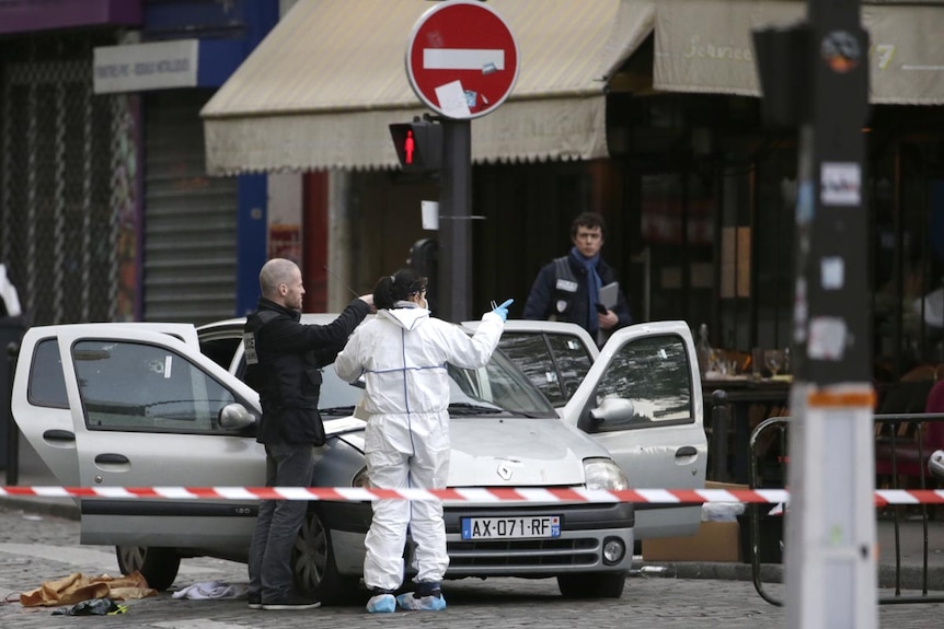 Forensics investigate car riddled with bullet holes in Paris