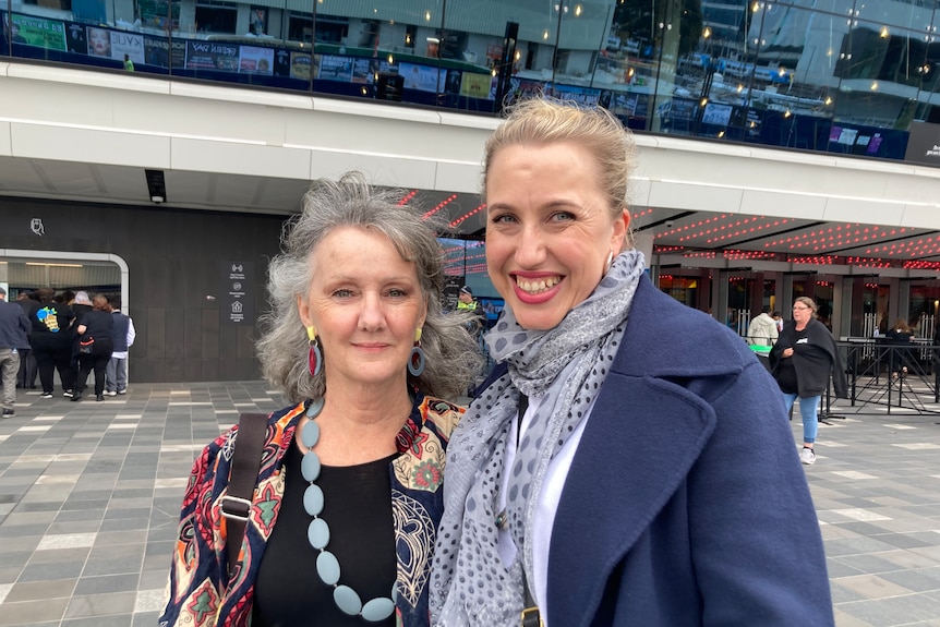 Two women attending Gudinski memorial