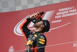 Australia's Daniel Ricciardo does a "shoey" on the podium after the Austrian Formula One Grand Prix.
