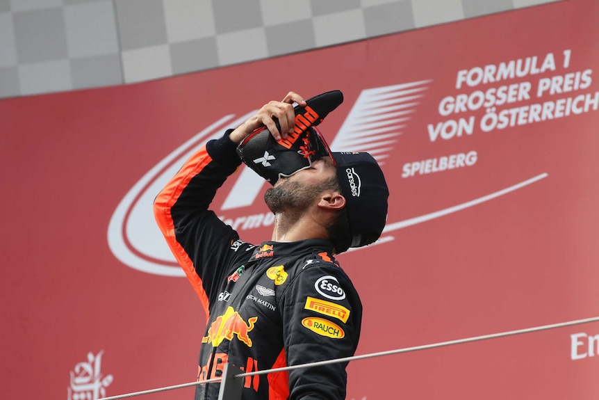 Daniel Ricciardo drinks sparkling wine from his racing boot at the Austrian F1 GP