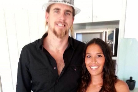 Ben gerring stands indoors in a black shirt and white hat alongside Jasmine Boyer in blue.