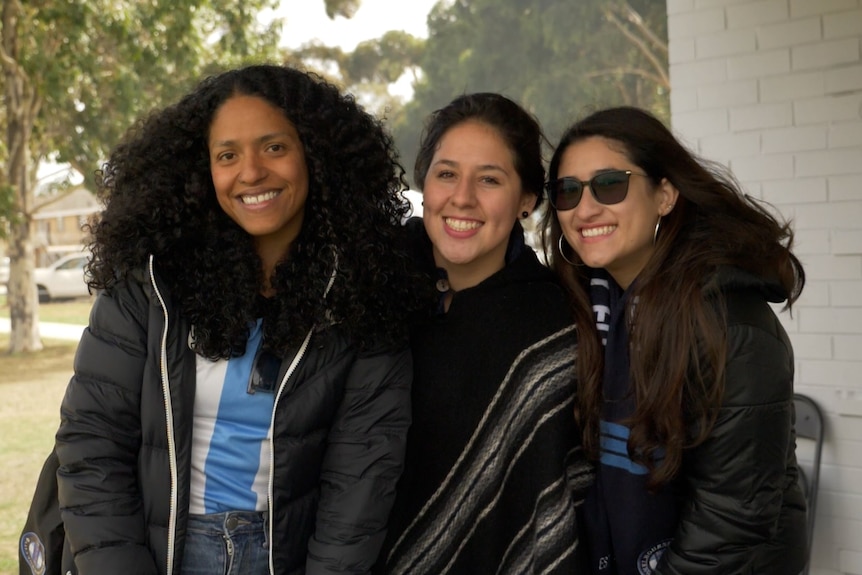 Three women who are Argentina fans at a fan day in Melbourne.