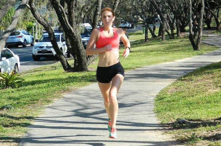 Alexandra Blake runs along a footpath