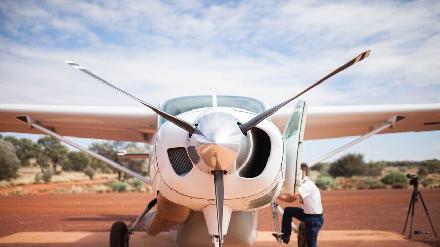 Pilot Harvey Salameh climbs into his plane in remote WA.